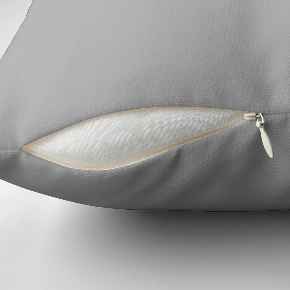 Soft, plush pillow featuring a sleeping tuxedo cat in a comfortable lounging pose