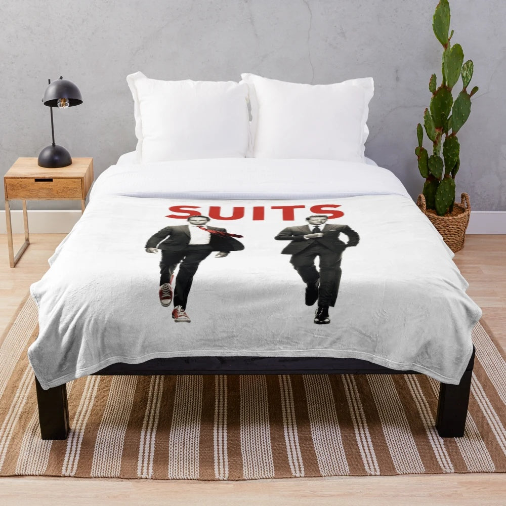 Tuxedo-inspired plush blanket with a minimal black and white design