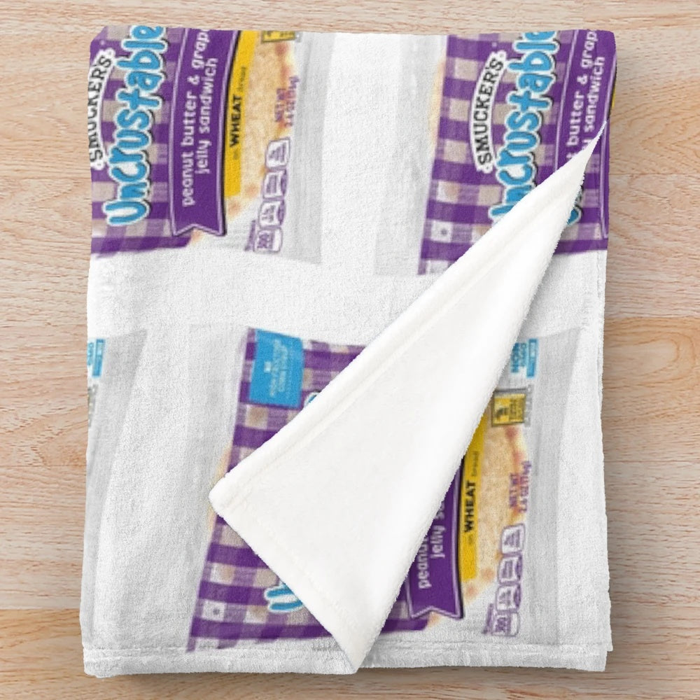 Uncrustables-inspired plush blanket with peanut butter and grape jelly design