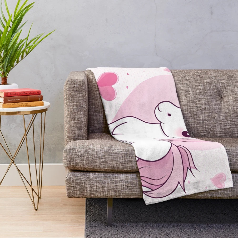 Soft and cuddly pink plush blanket featuring whimsical unicorns and hearts