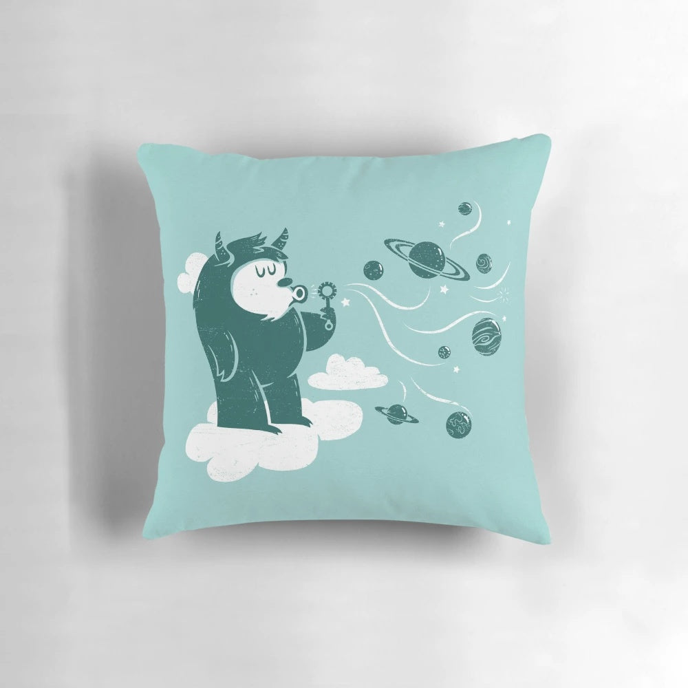 Whimsical plush pillow featuring a cute cartoon monster design with planets, stars, and other space-themed elements.