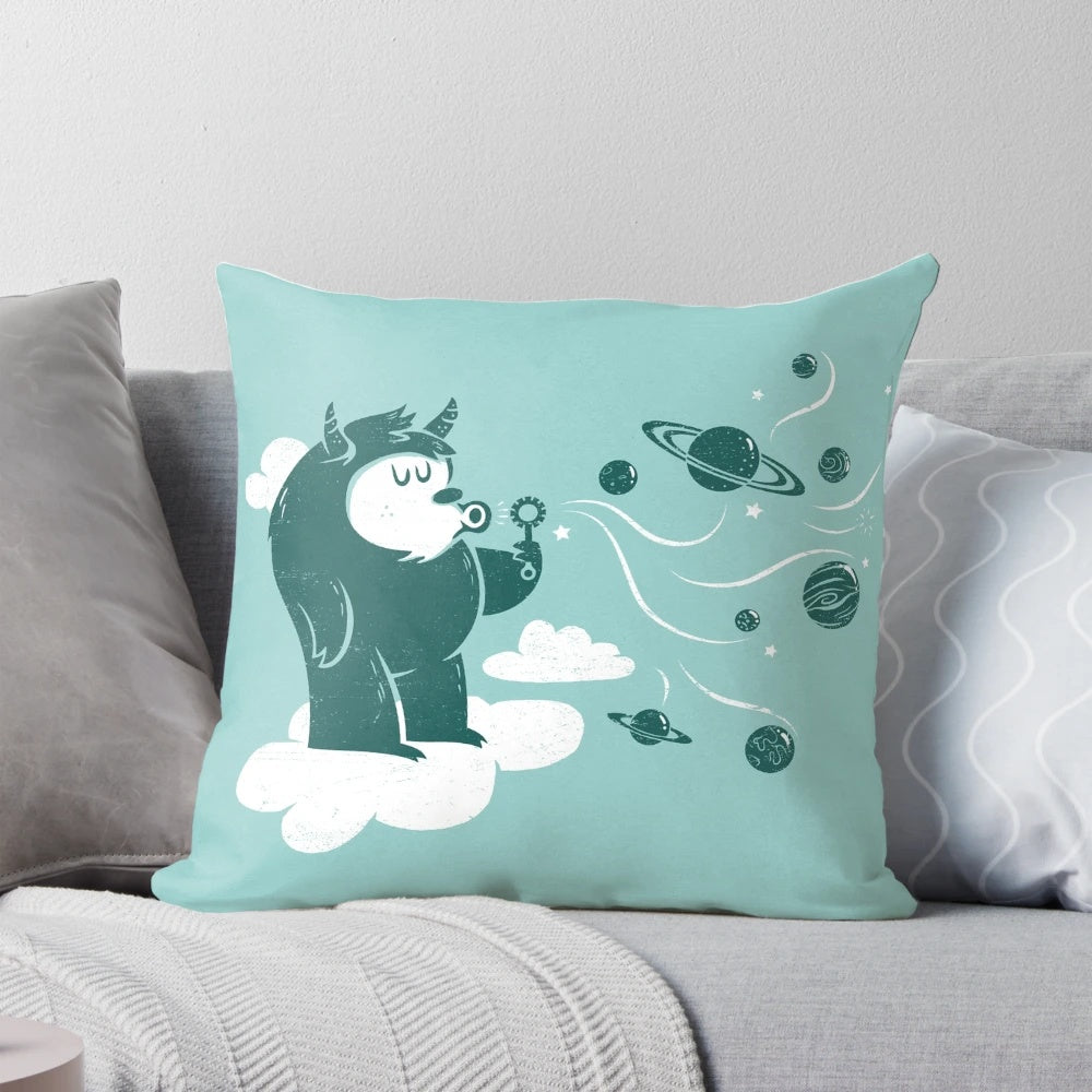 Whimsical plush pillow featuring a cute cartoon monster design with planets, stars, and other space-themed elements.