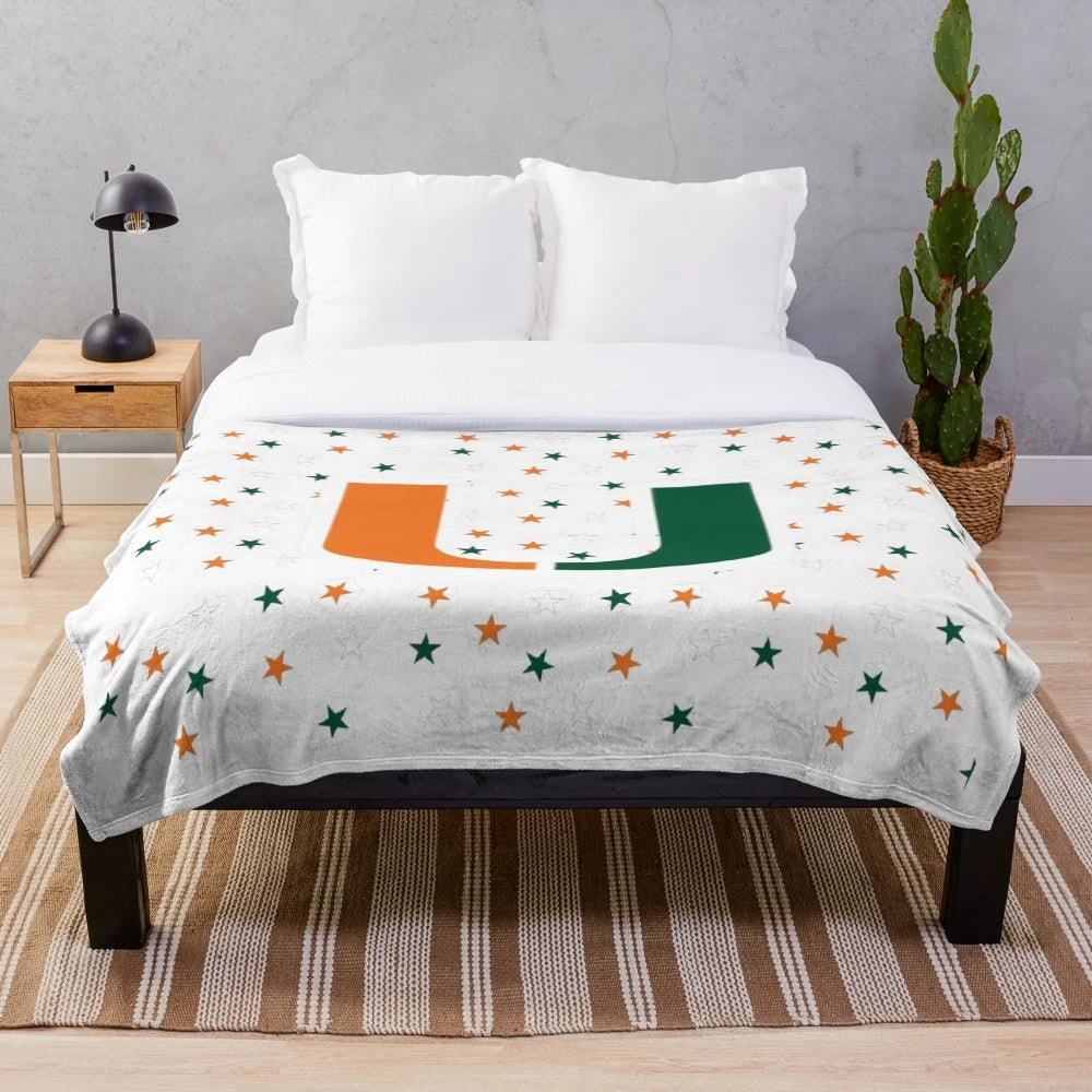 University of Miami Hurricanes logo on a plush orange and green blanket