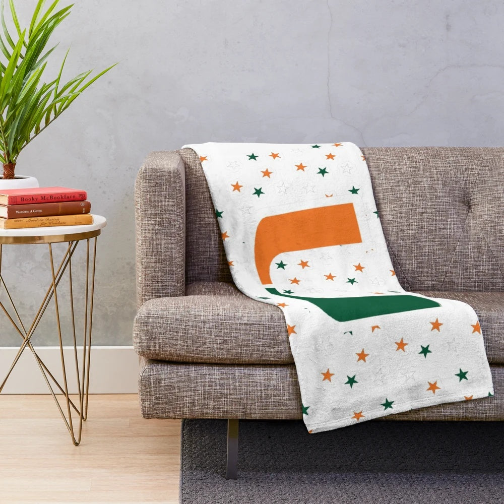 University of Miami Hurricanes logo on a plush orange and green blanket