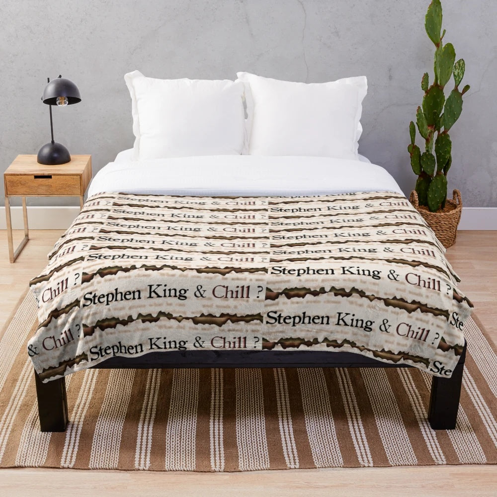 Plush blanket featuring a Stephen King-themed design