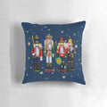 Festive holiday nutcracker figures and a cozy Christmas fireplace scene on a soft, plush pillow
