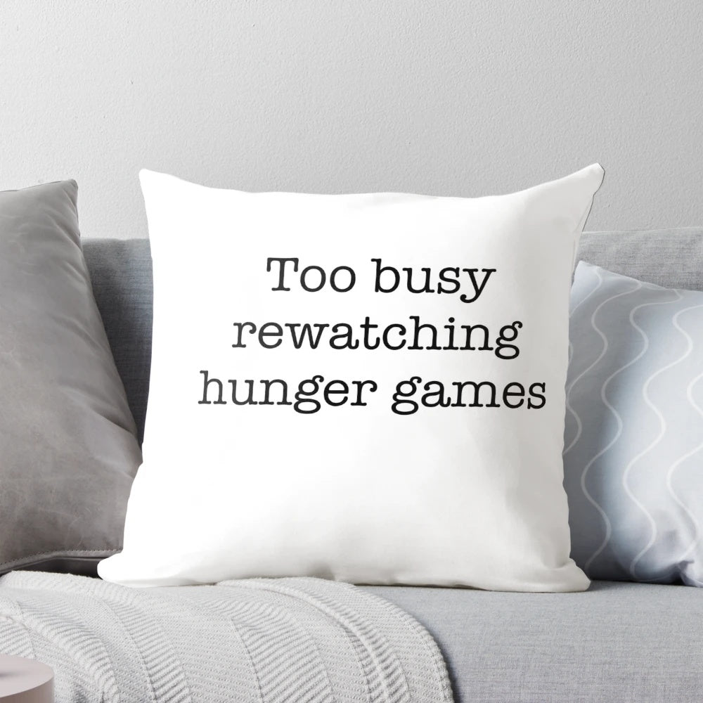 Hunger Games themed throw pillow featuring Katniss Everdeen and Peeta Mellark