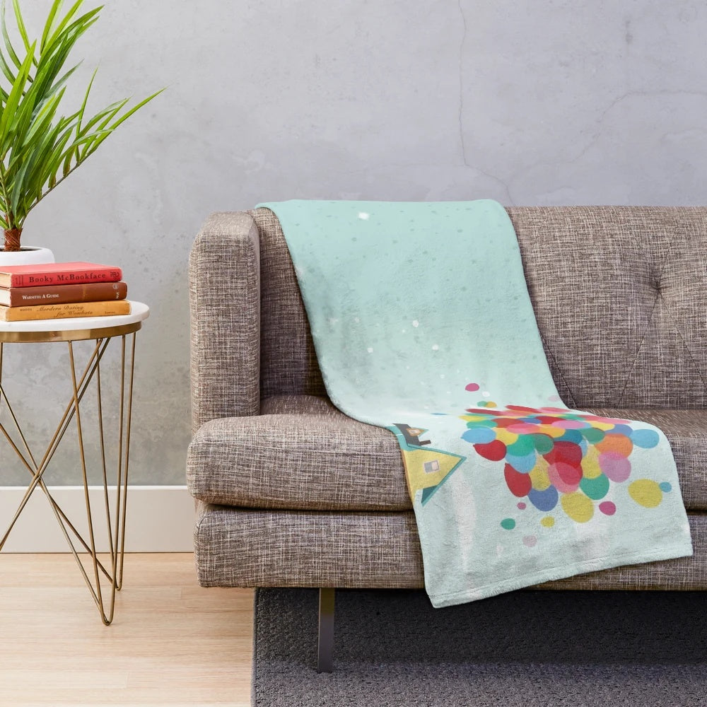 Soft plush blanket inspired by the Pixar movie Up, featuring the iconic house and balloons