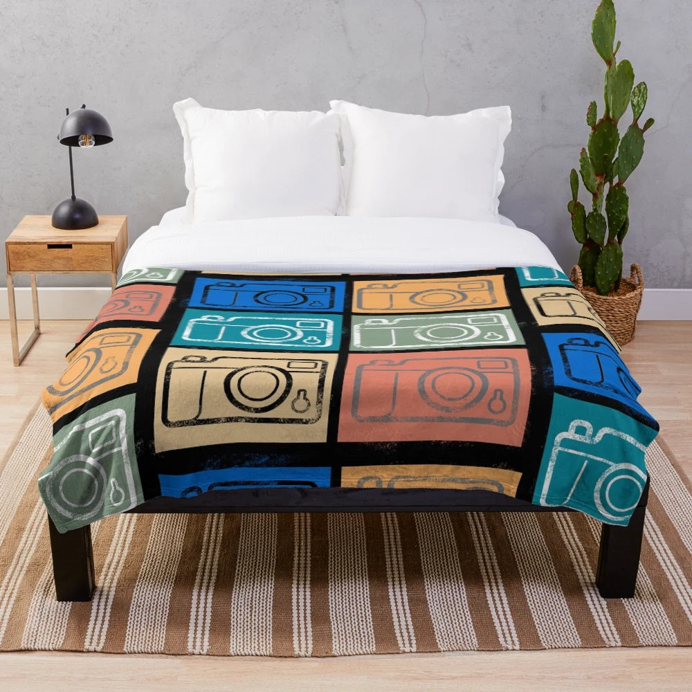 Soft and cozy plush blanket featuring a vintage camera design