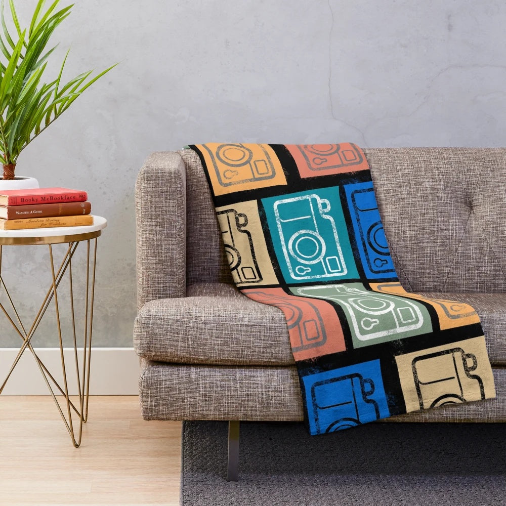 Soft and cozy plush blanket featuring a vintage camera design