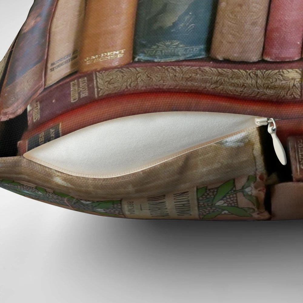 Vintage-style pillow featuring stacks of antique books and book spines in a cozy, rustic design