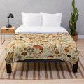 Vintage-inspired plush blanket with a collection of mushroom designs in earthy tones
