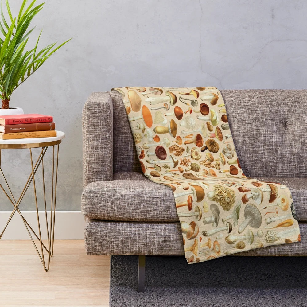 Vintage-inspired plush blanket with a collection of mushroom designs in earthy tones