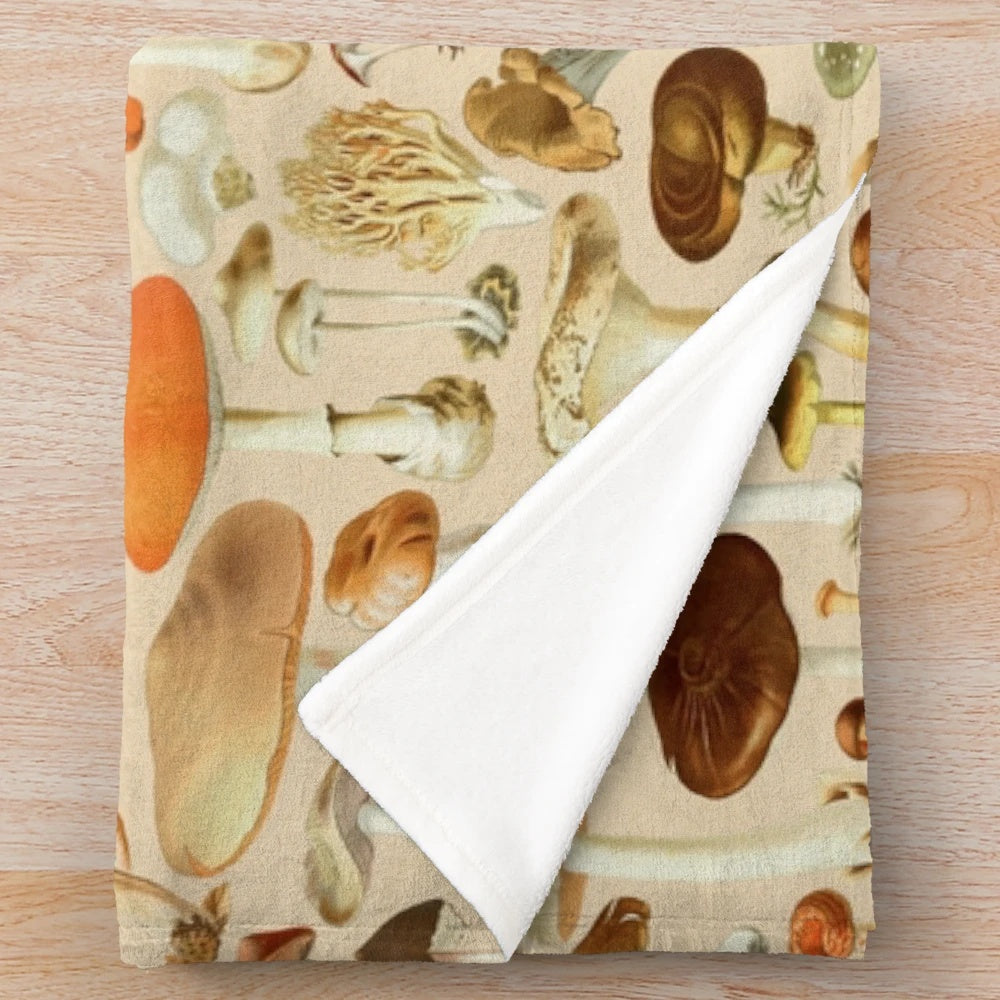 Vintage-inspired plush blanket with a collection of mushroom designs in earthy tones