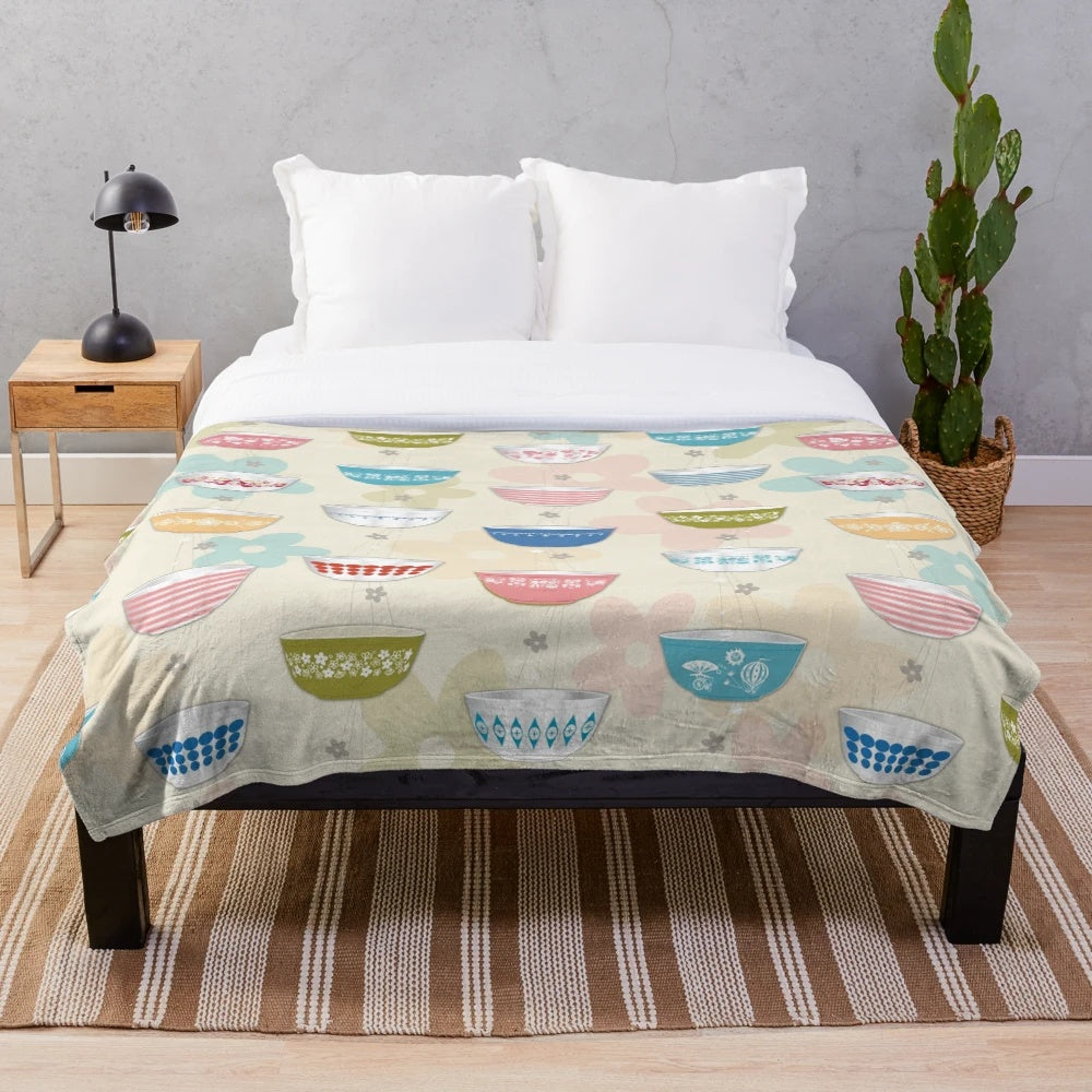 Vintage-inspired plush blanket featuring a collage of iconic Pyrex bowl designs