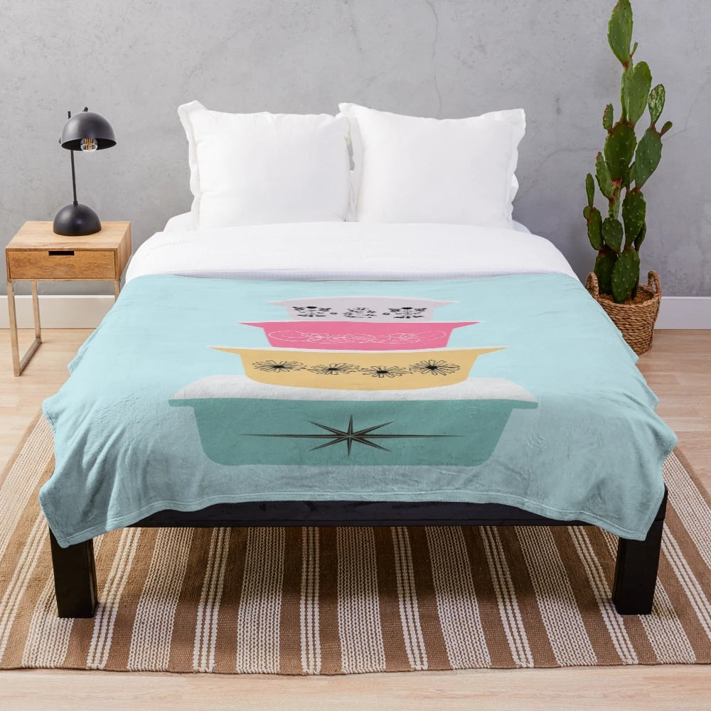 Soft and vibrant plush blanket featuring a retro Pyrex-inspired floral and starburst pattern