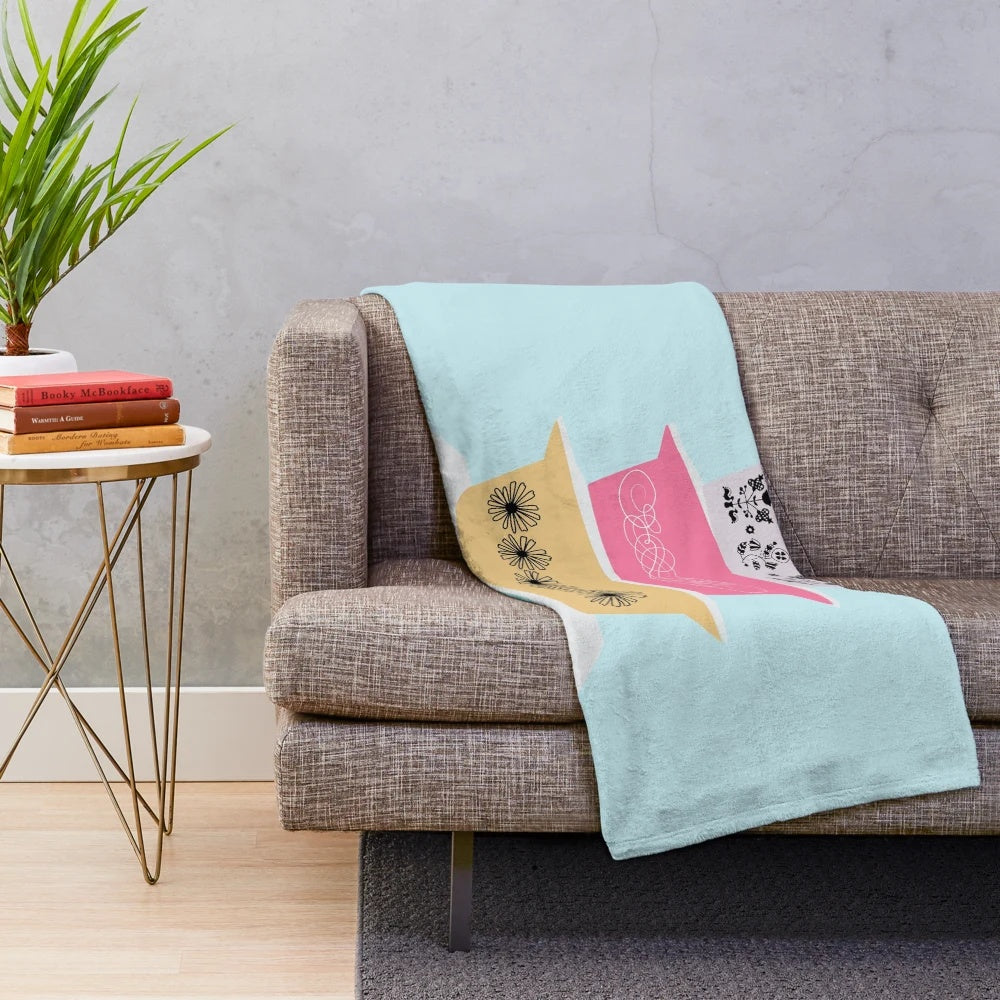 Soft and vibrant plush blanket featuring a retro Pyrex-inspired floral and starburst pattern