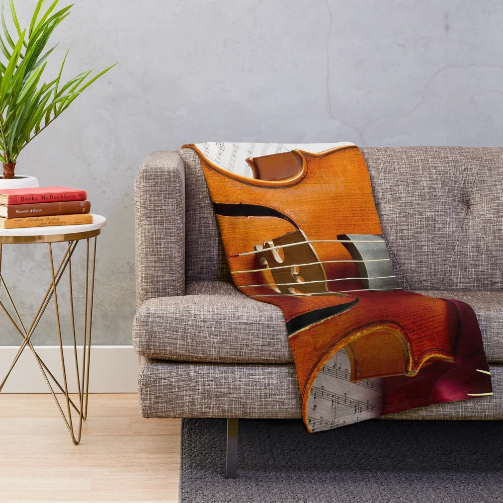 A soft, plush blanket featuring a viola, perfect for music enthusiasts.