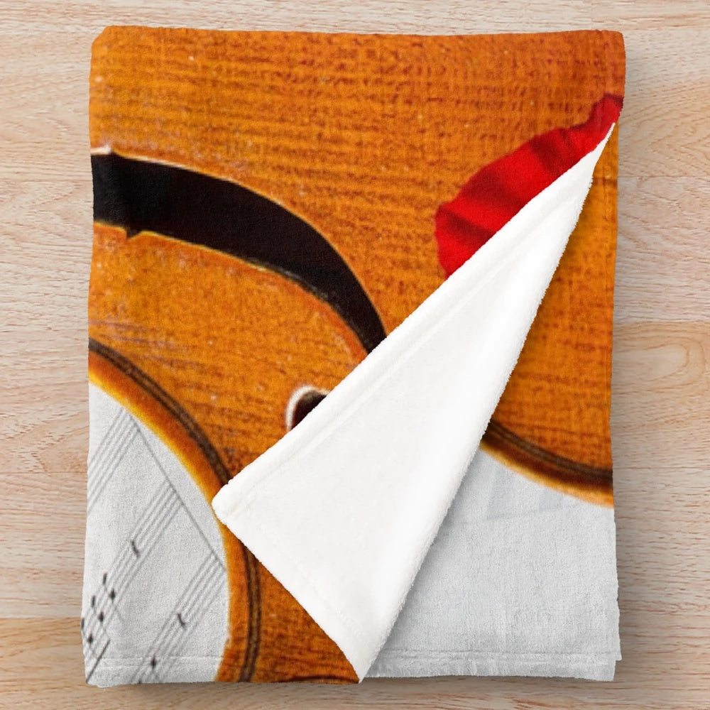 A soft, plush blanket featuring a viola, perfect for music enthusiasts.
