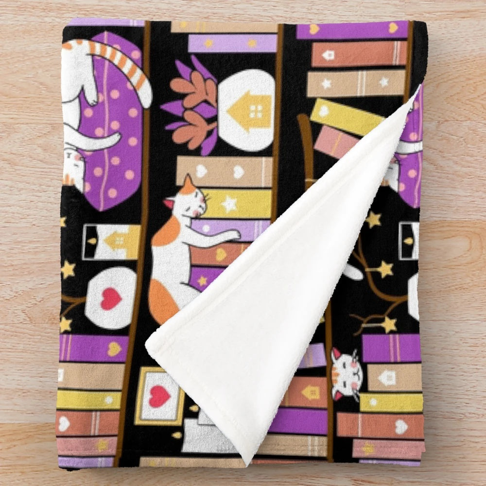 Violet plush blanket with a cute cat design, perfect for a cozy reading nook