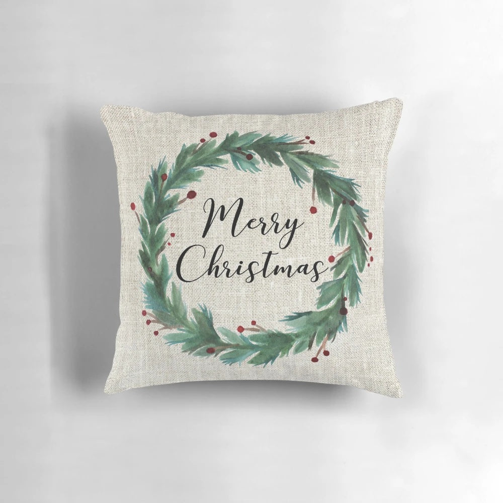 A watercolor-style Christmas wreath printed on a soft, plush pillow.