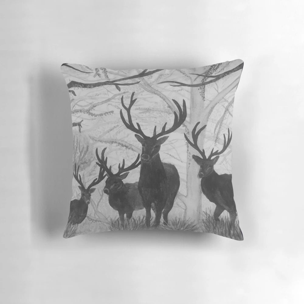 Decorative throw pillow featuring a soft, watercolor illustration of a deer in a winter forest scene.