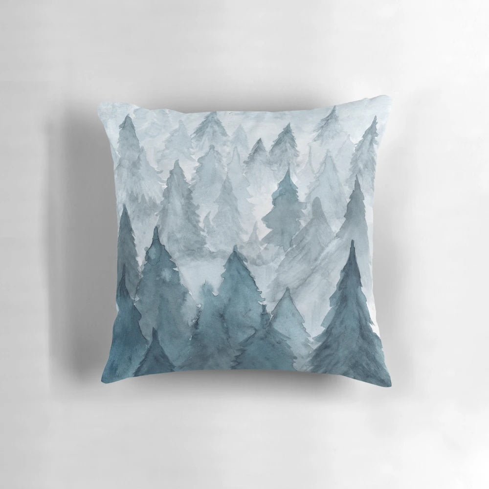Watercolor painting of a snowy forest landscape on a decorative pillow
