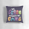 A plush 'We Scare Because We Care' monster-themed throw pillow with stylish typography