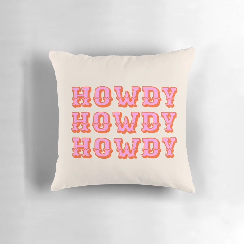 Soft, pink pillow with "Howdy" text, perfect for adding a touch of Texas charm to any room.