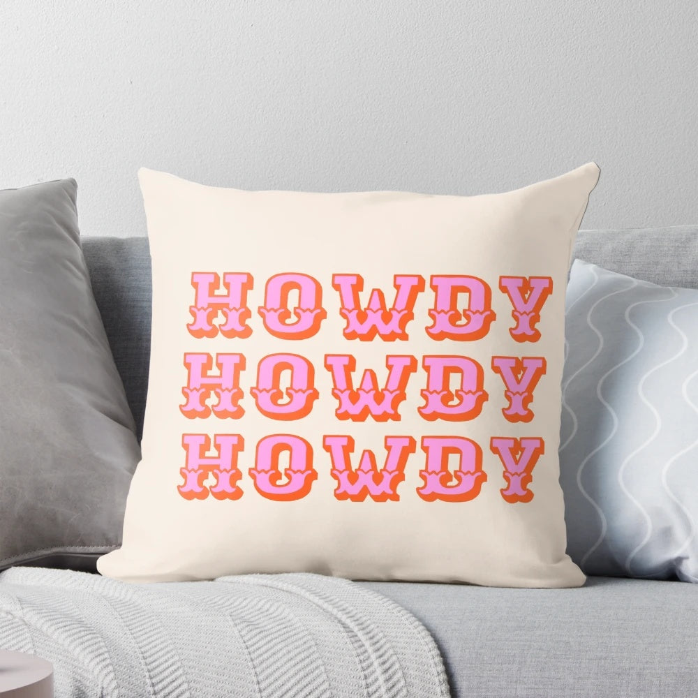 Soft, pink pillow with "Howdy" text, perfect for adding a touch of Texas charm to any room.