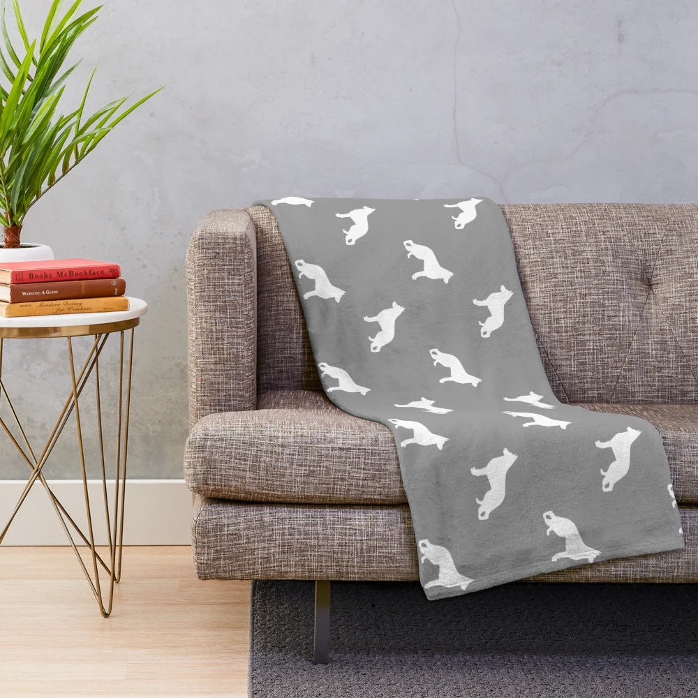White German Shepherd dog silhouette on a plush blanket