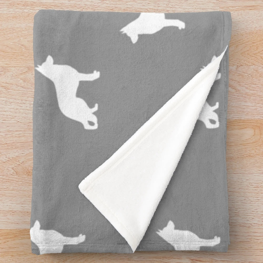 White German Shepherd dog silhouette on a plush blanket