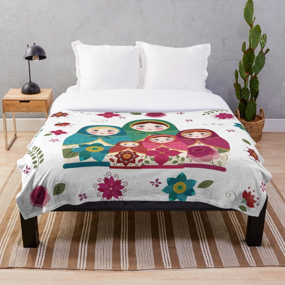 White plush blanket with Russian nesting dolls or matryoshka pattern