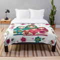 White plush blanket with Russian nesting dolls or matryoshka pattern
