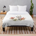 White Swiss Shepherd dog on a plush blanket with wildflowers