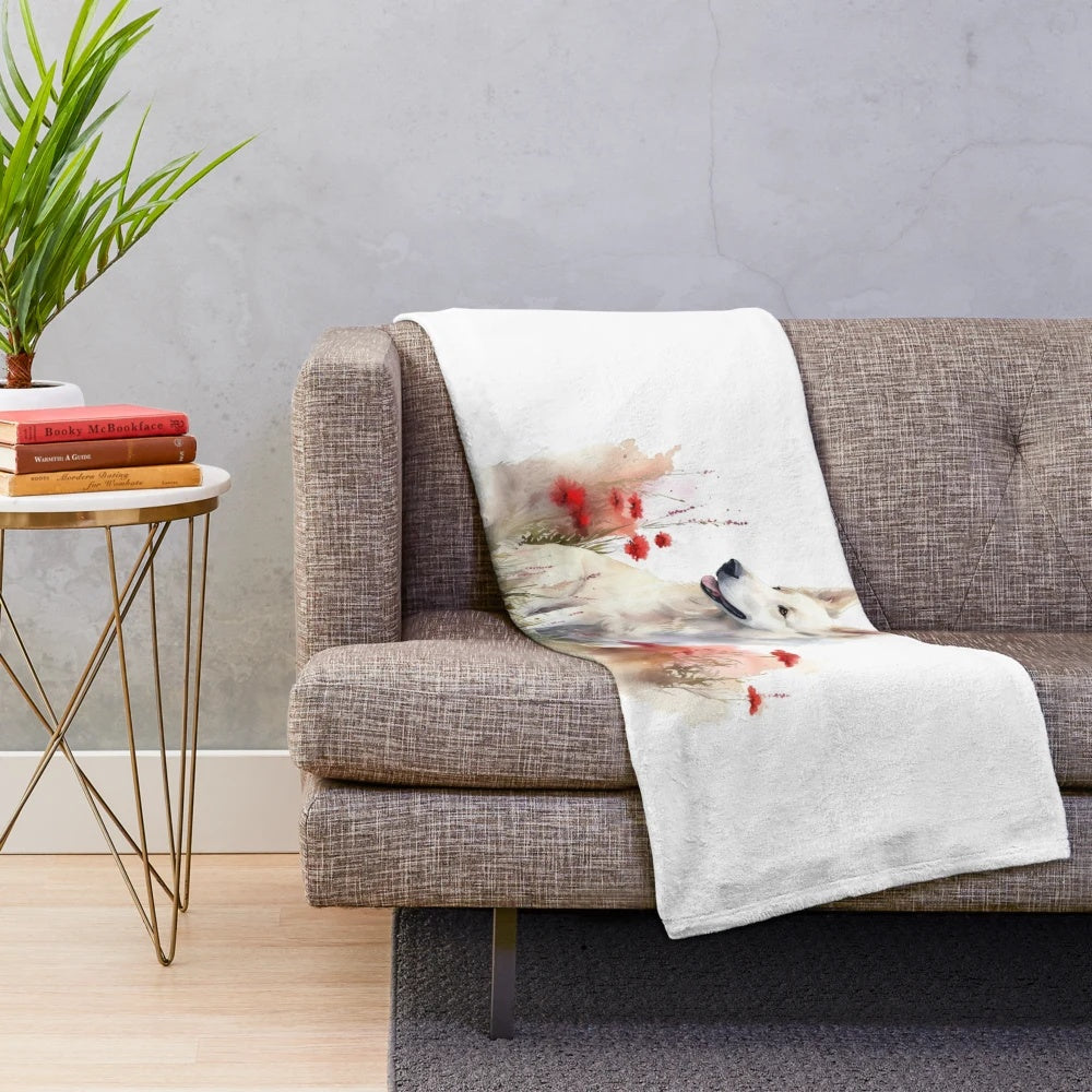White Swiss Shepherd dog on a plush blanket with wildflowers