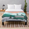 Plush blanket featuring a winter landscape with a bus in the woods