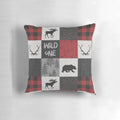 A vibrant red, black, and grey patchwork pillow with a woodland animal design, perfect for a rustic cabin or lodge.