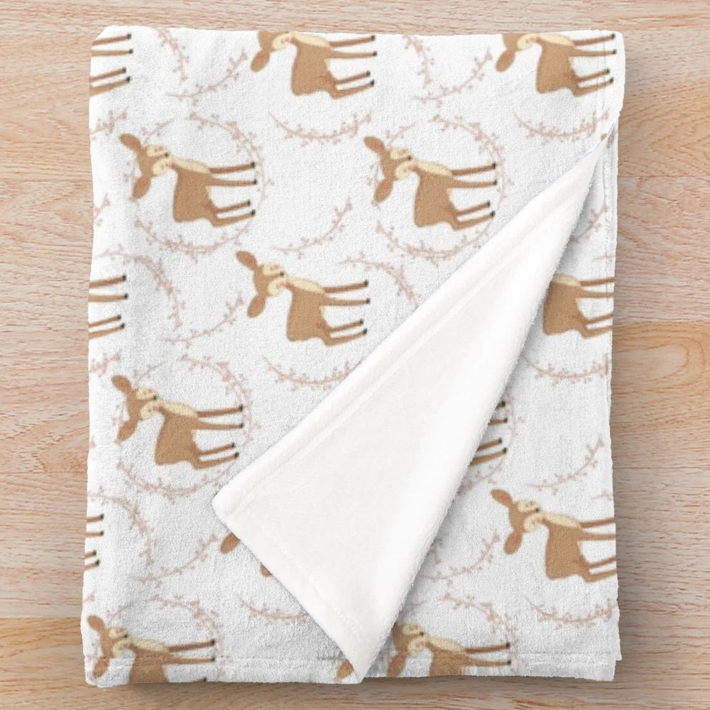 Plush blanket with a wildlife pattern featuring a deer design