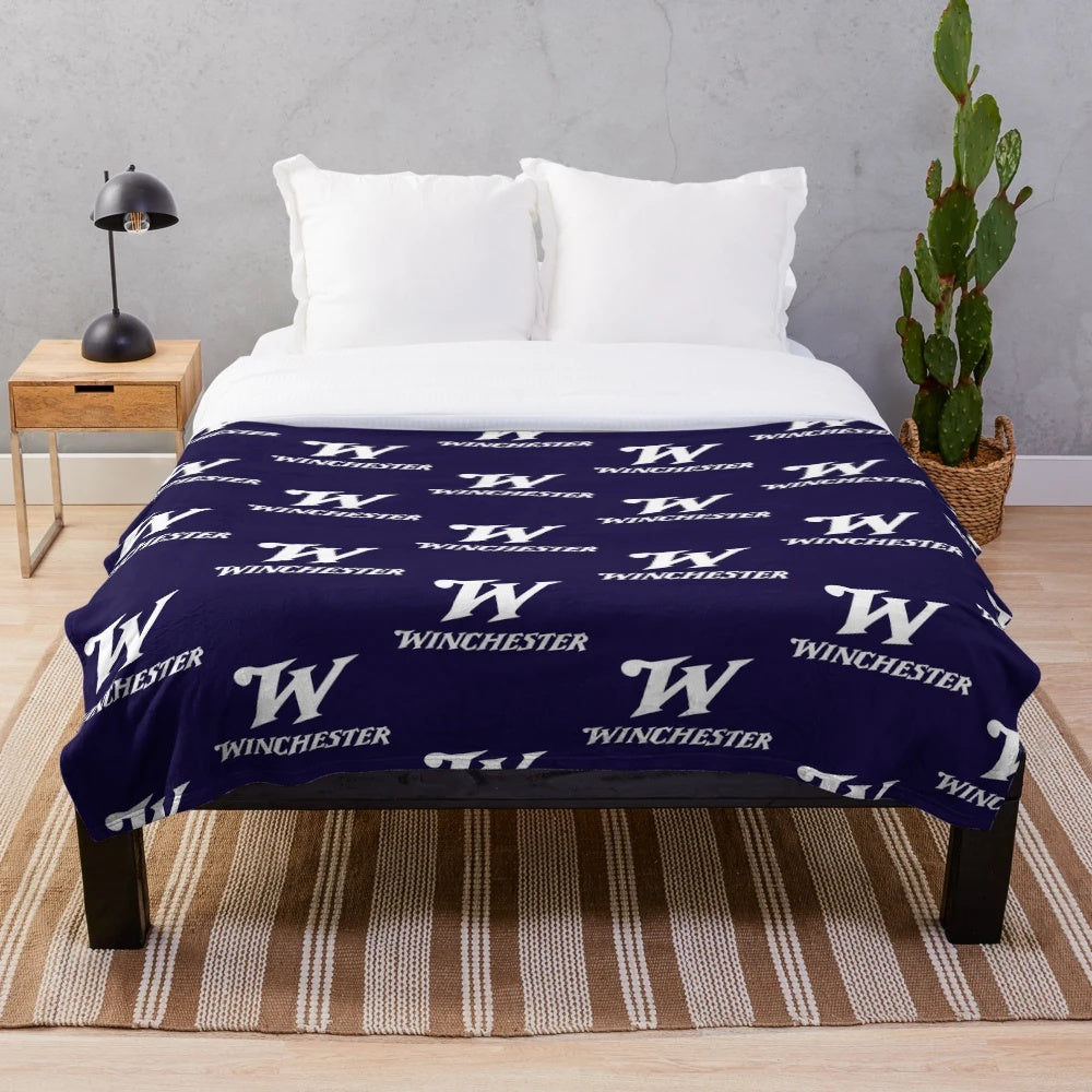 Winchester-inspired plush blanket with rifle and arms logo