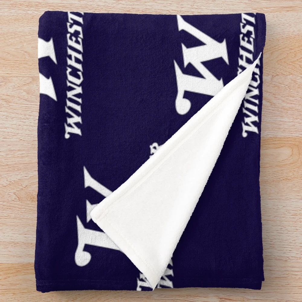 Winchester-inspired plush blanket with rifle and arms logo