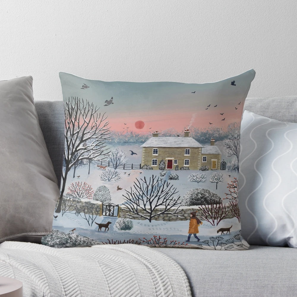 Cozy winter landscape pillow featuring a snowy cottage scene with birds and a dog walker at sunset