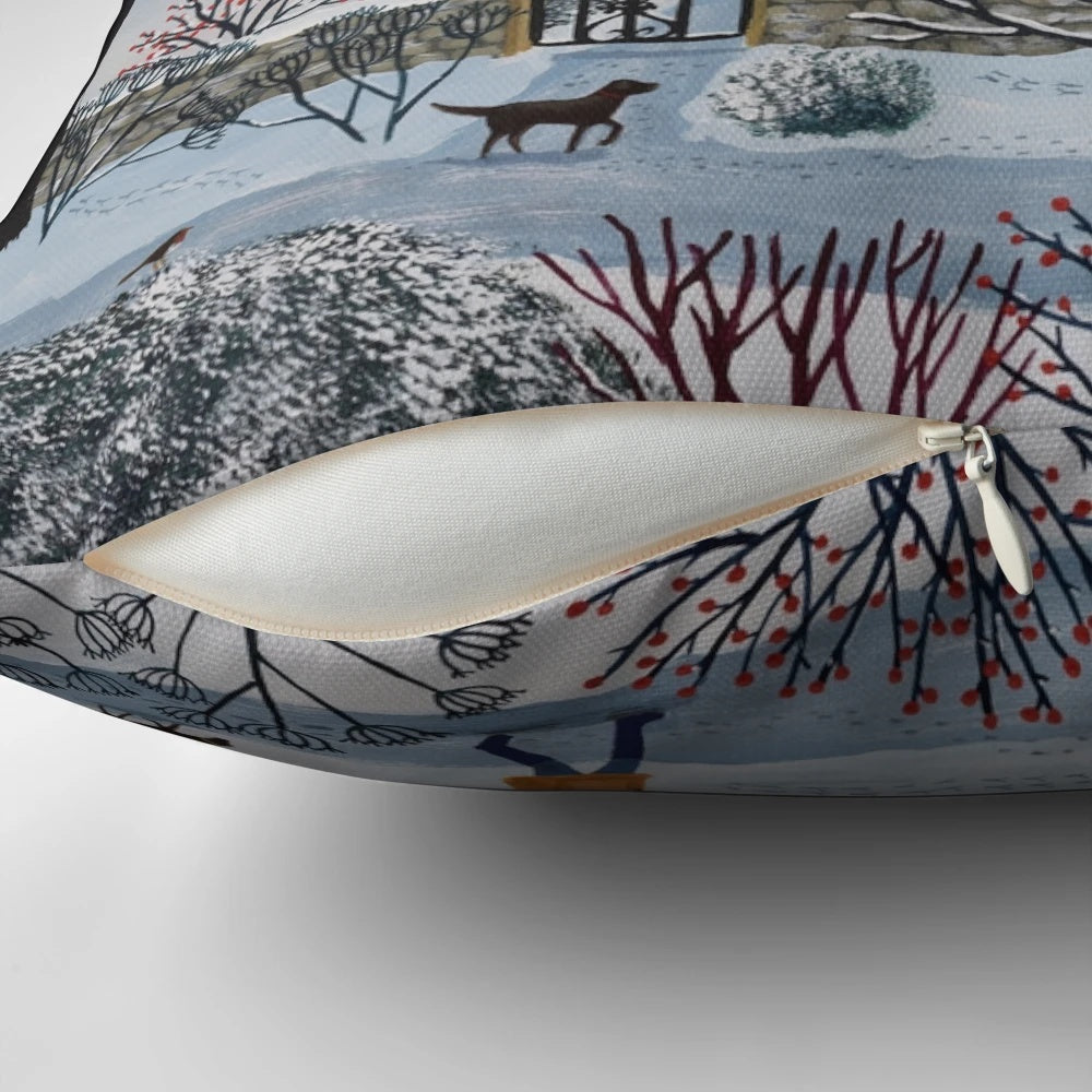 Cozy winter landscape pillow featuring a snowy cottage scene with birds and a dog walker at sunset