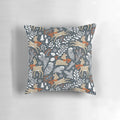 Dark grey pillow featuring a winter deer motif in a snowy forest setting