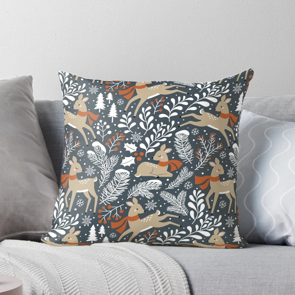Dark grey pillow featuring a winter deer motif in a snowy forest setting