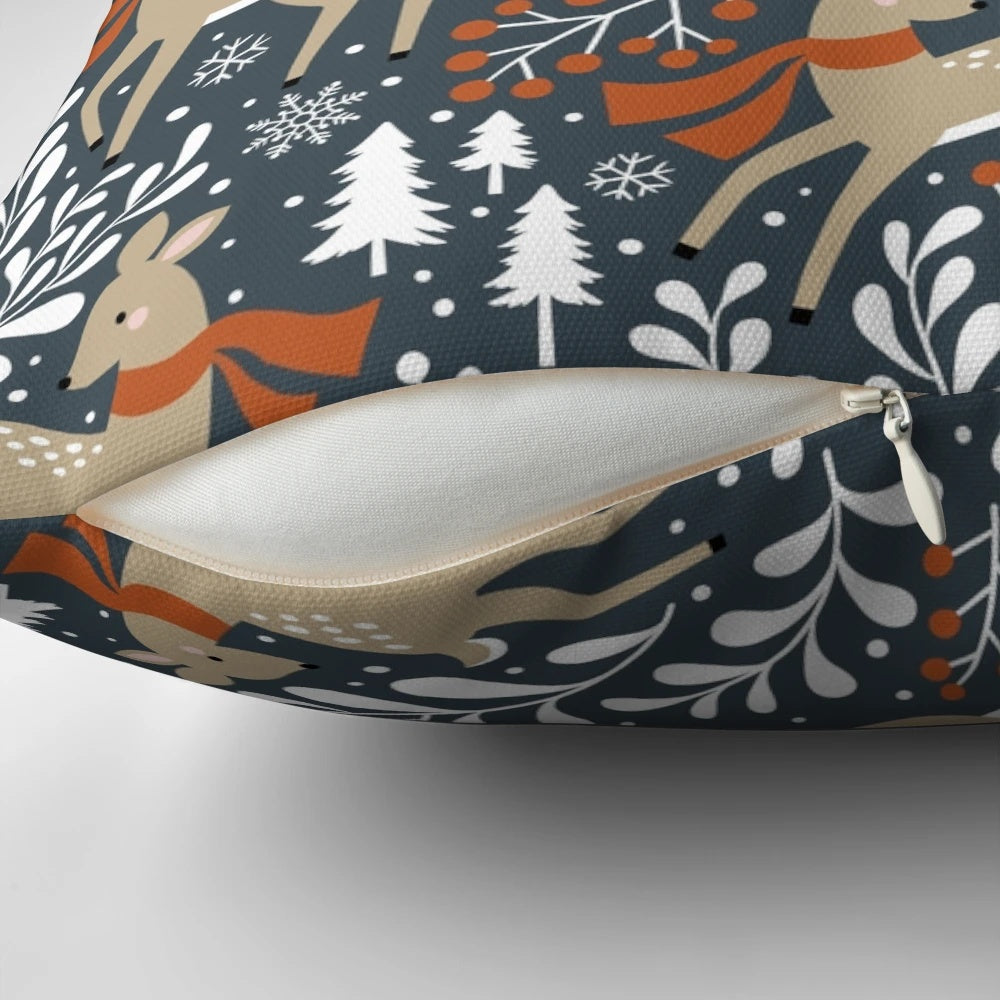 Dark grey pillow featuring a winter deer motif in a snowy forest setting