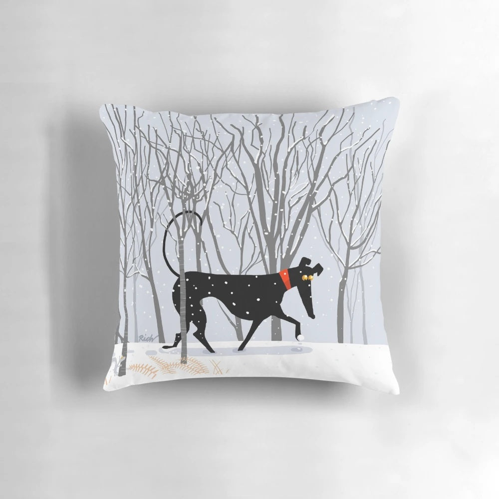 A soft, plush pillow featuring a winter-themed design with a greyhound, whippet, or lurcher dog.