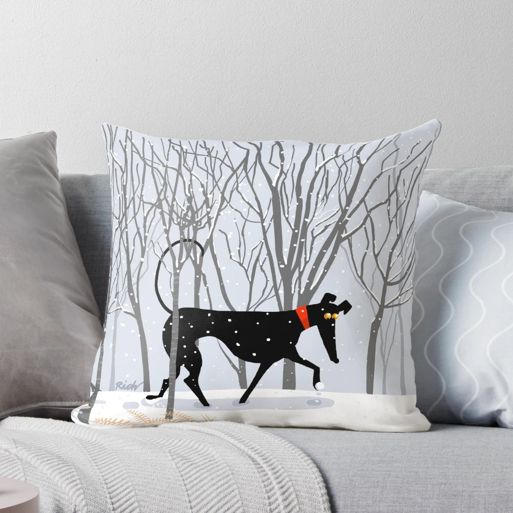 A soft, plush pillow featuring a winter-themed design with a greyhound, whippet, or lurcher dog.