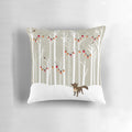 A cozy winter landscape pillow featuring a snowy forest scene with a majestic wolf and festive Christmas tree.