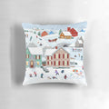 A soft, plush pillow featuring a winter scene with a snowman, trees, and a house in the snow.